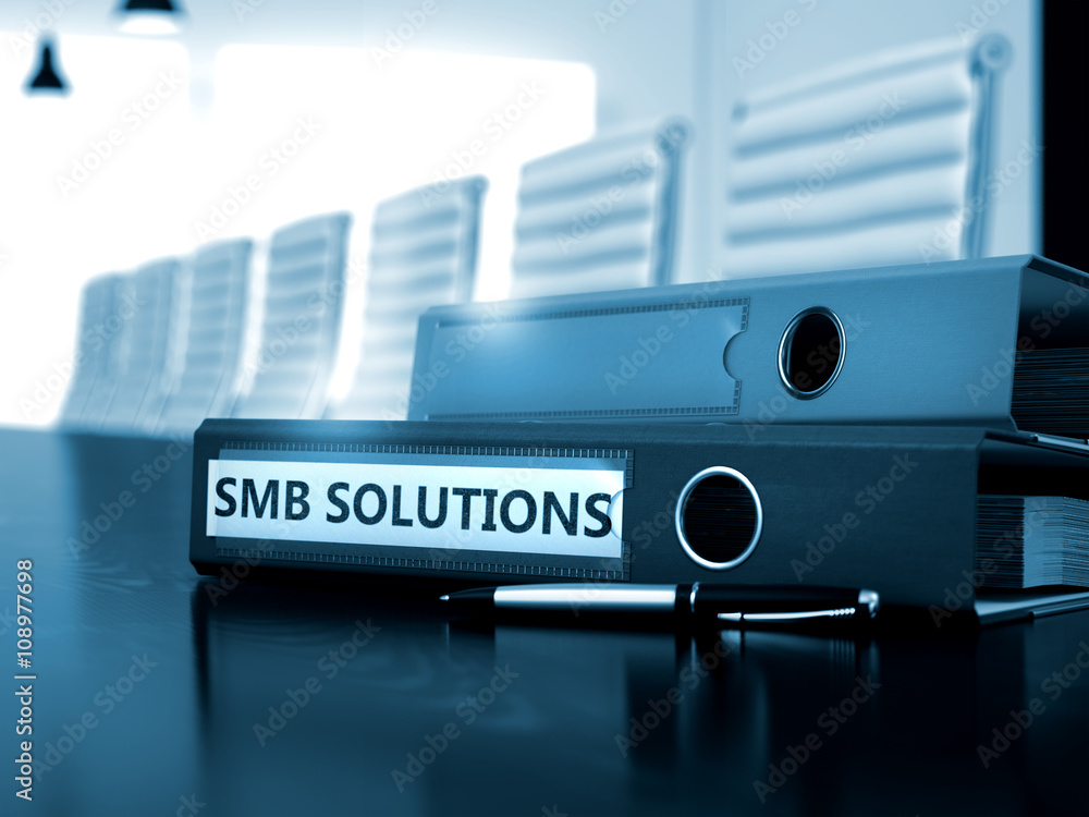 Poster file folder with inscription smb solutions on working office desktop. smb solutions - file folder on