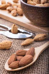 almonds set on the wooden plate, morning light,close up