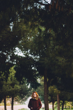 Portrait of redhead woman in the forest