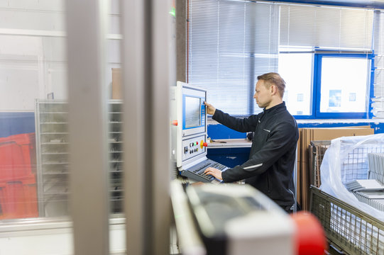 Man working at packaging machine in factory