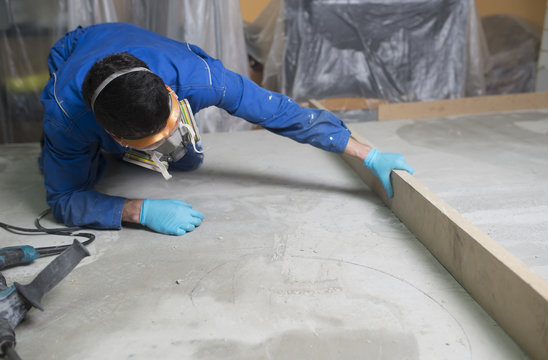 Worker checking the level of the concrete floor