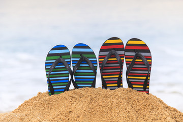 Fototapeta premium Flip flops on the sandy beach