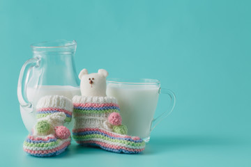 Glass of the milk on plain aquamarine background