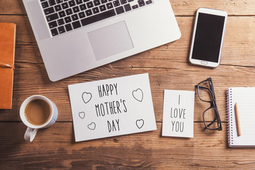 Happy mothers day sign. Studio shot, wooden background.