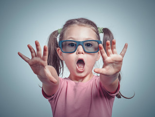 Fototapeta premium excited cute little girl with 3d glasses watching 3d movie