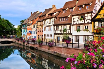 Fototapeta na wymiar Beautiful canals of Colmar, France with late day reflections
