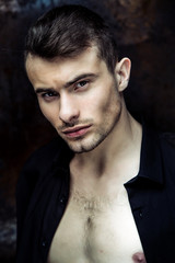 Fototapeta premium Close up portrit of Strong Athletic Man Fitness Model on dark background 