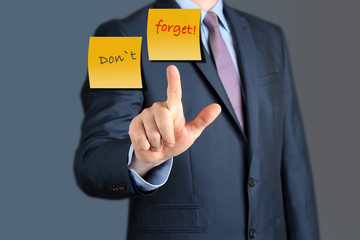 Businessman touching Dont Forget word.  business concept