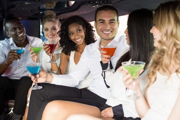 Well dressed people drinking cocktails