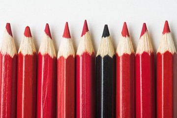 Red pencils and one black pencil, individuality concept