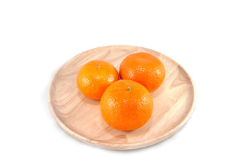orange in a wood dish