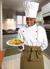 Female Chef With Tray Of Food In Hand..