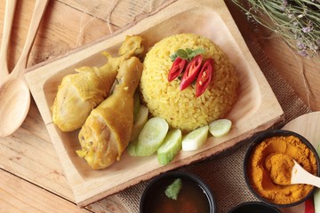 Chicken biryani with rice delicious and sauce.