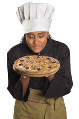 Pretty cook woman smelling pizza.