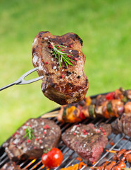 Delicious grilled meat with vegetable on a barbecue grill.