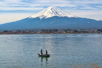 small fishing boat with young fishermen in the kawaguchiko lake