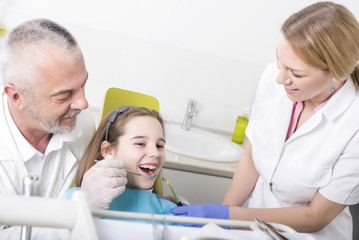 Girl having teeth examination at dental clinic. People, dentist, stomatology and health care concept