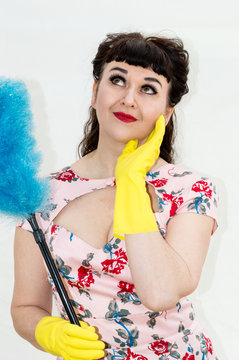 1950s Retro Style Woman With Duster And Rubber Gloves.