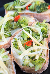 Toasts with broccoli, chili pepper and cheese flakes
