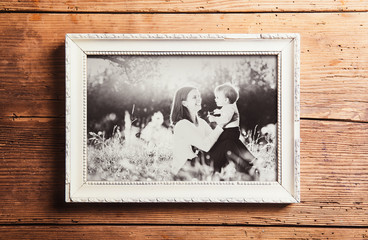 Mothers day composition. Picture frame. Wooden background. Studi