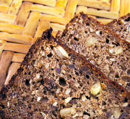 Bread with seeds on woven straw background