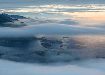 Scenic landscape on Lofoten islands, Reine. Village near great mountains in the clouds 