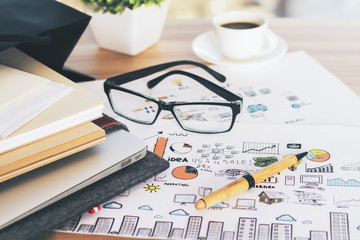 Notepads and glasses on sketch