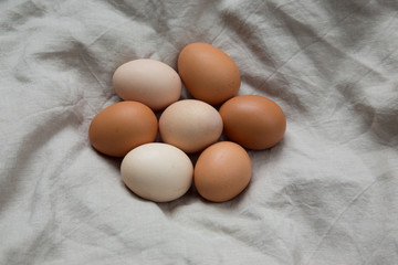 Raw eggs on linen textile