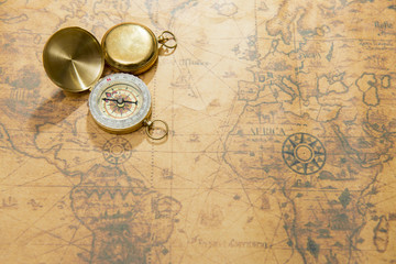 Fototapeta na wymiar old compass on vintage map