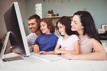 Close-up of happy family looking in computer