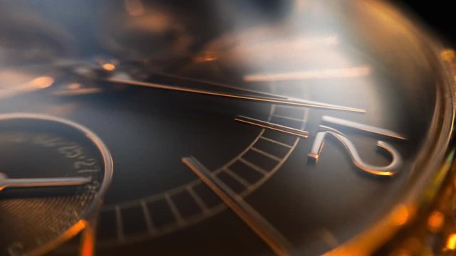 Ultra macro shot of beautiful ladies golden watch, arrow points at twelve o`clock, large depth of field effect. Smooth round camera slides along the center. Big bokeh glitching around.