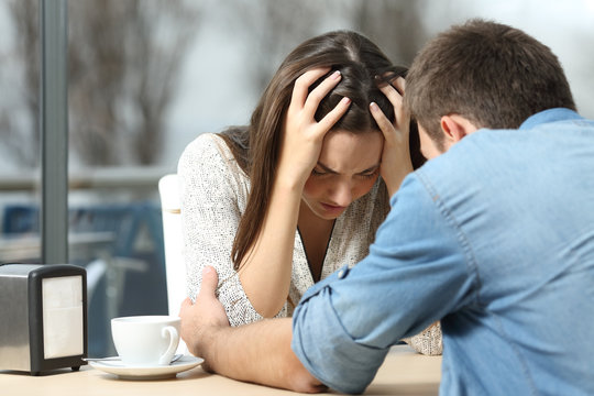 Man comforting a sad depressed girl