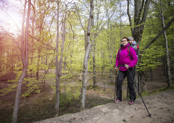 Mom walks in the forest with a child, a child in the children carry.