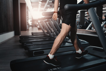 Fototapeta na wymiar People walkingin machine treadmill at fitness gym club