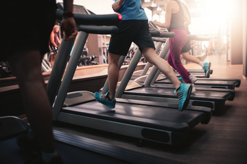 People running in machine treadmill at fitness gym club - obrazy, fototapety, plakaty