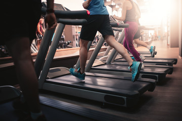 People running in machine treadmill at fitness gym club - 108992094