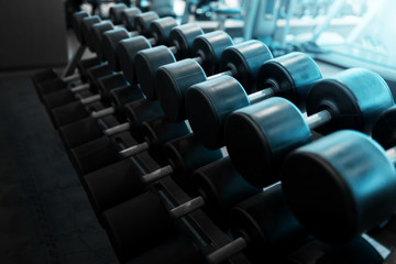 Obraz na płótnie Canvas Metal dumbbells lying on gym fitness club