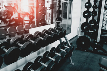 Metal dumbbells lying on gym fitness club