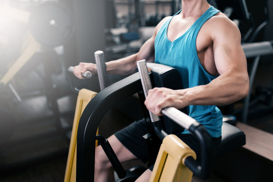 Man working on fitness machine at gym