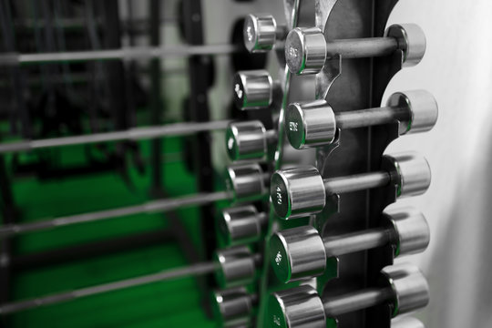 Metal dumbbells lying on gym fitness club