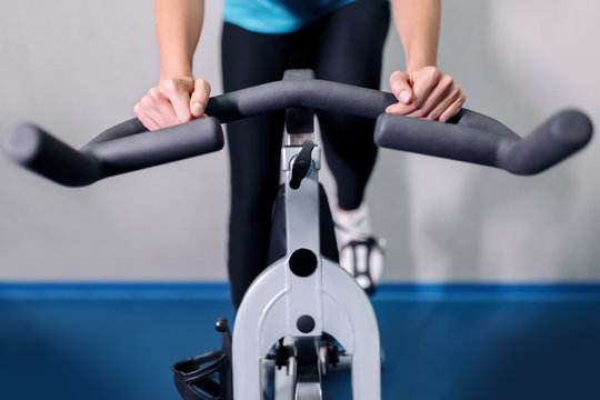 Woman on fitness exercise bike at indoor