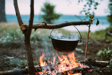 Fish soup to cook on fire in nature. Outdoors photo.