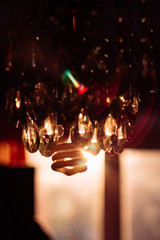 Glass chandelier against a sunset. Interior photo.