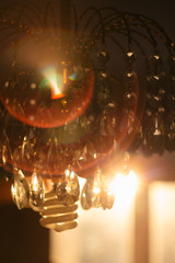 Glass chandelier against a sunset. Interior photo.