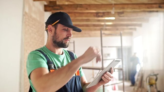 Renovation: man is measuring and taking notes.