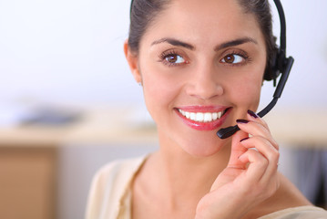 Close-up portrait of a customer service agent sitting at office