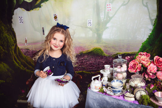 Beautiful smiling girl as Alice in Wonderland 