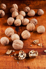 Many crushed walnuts on a rustic wooden table