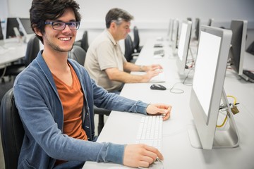Obraz premium Portrait of happy student using computer