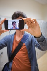 Student taking his selfie on smartphone